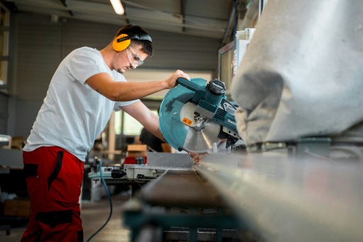 Worker operating a chop saw
